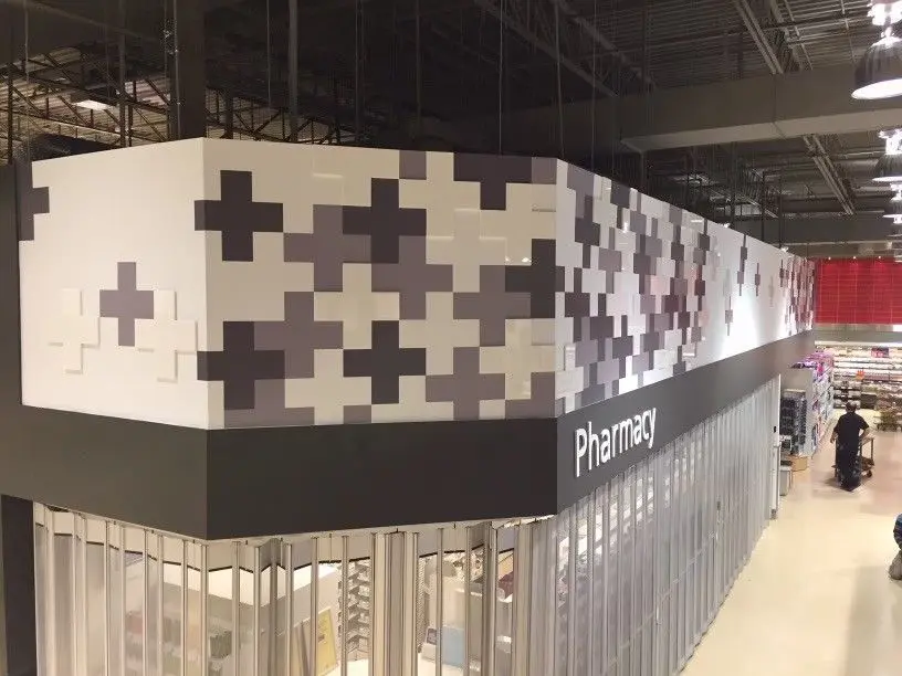 Pharmacy entrance with white and gray tile pattern.